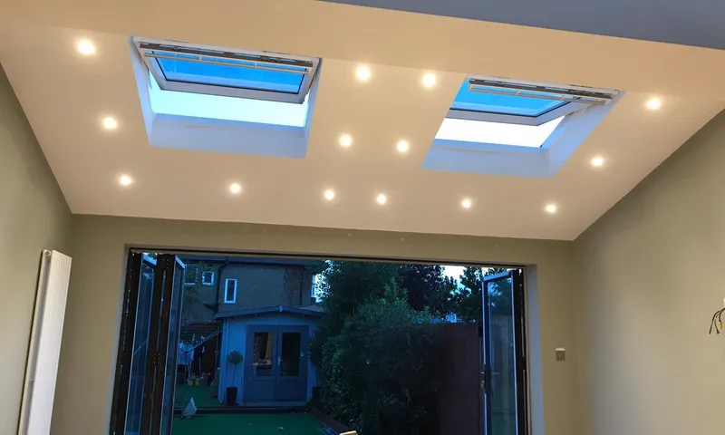 Inside a finished single-storey rear extension, with two opening rooflights, recessed downlights and bifold doors to the garden