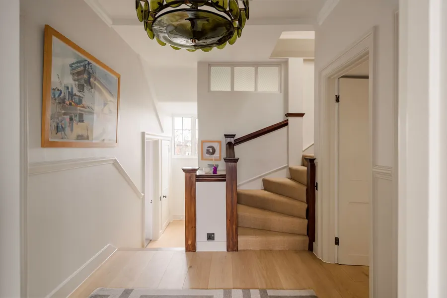 Landing with oak flooring and a carpeted staircase leading up, in the loft flat we refitted in North London