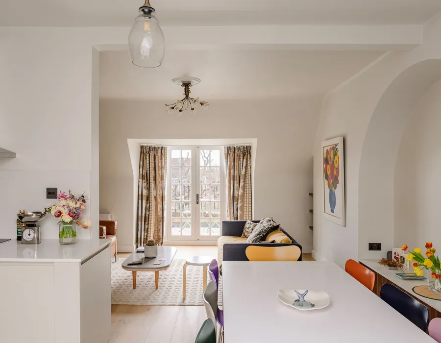 Loft flat we refitted, looking from the kitchen island through to the living room and French windows