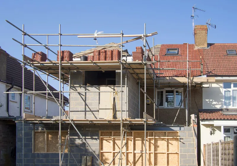 Rear house extension under construction, with timber framing and scaffolding