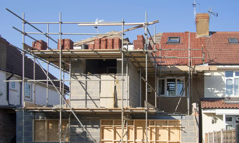 Rear house extension under construction, with timber framing and scaffolding